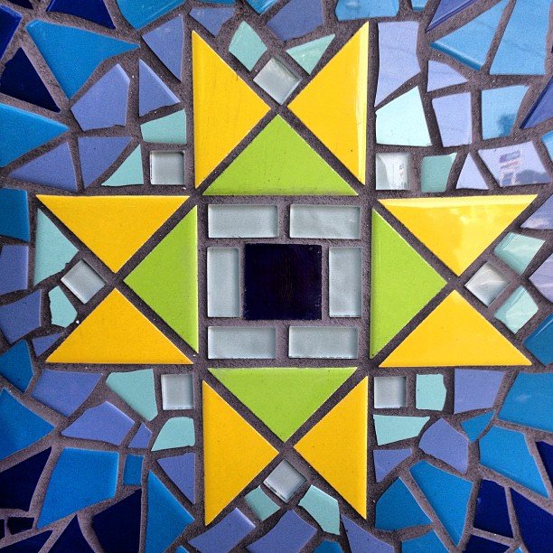 A star-shaped tile mosaic that is too beautiful to have been the side of a public trashcan in Oakland, California